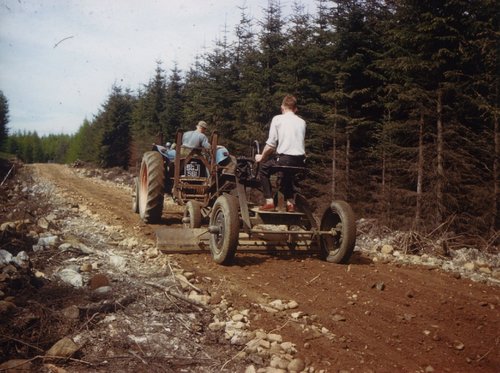 Farm machinery grading a forest track