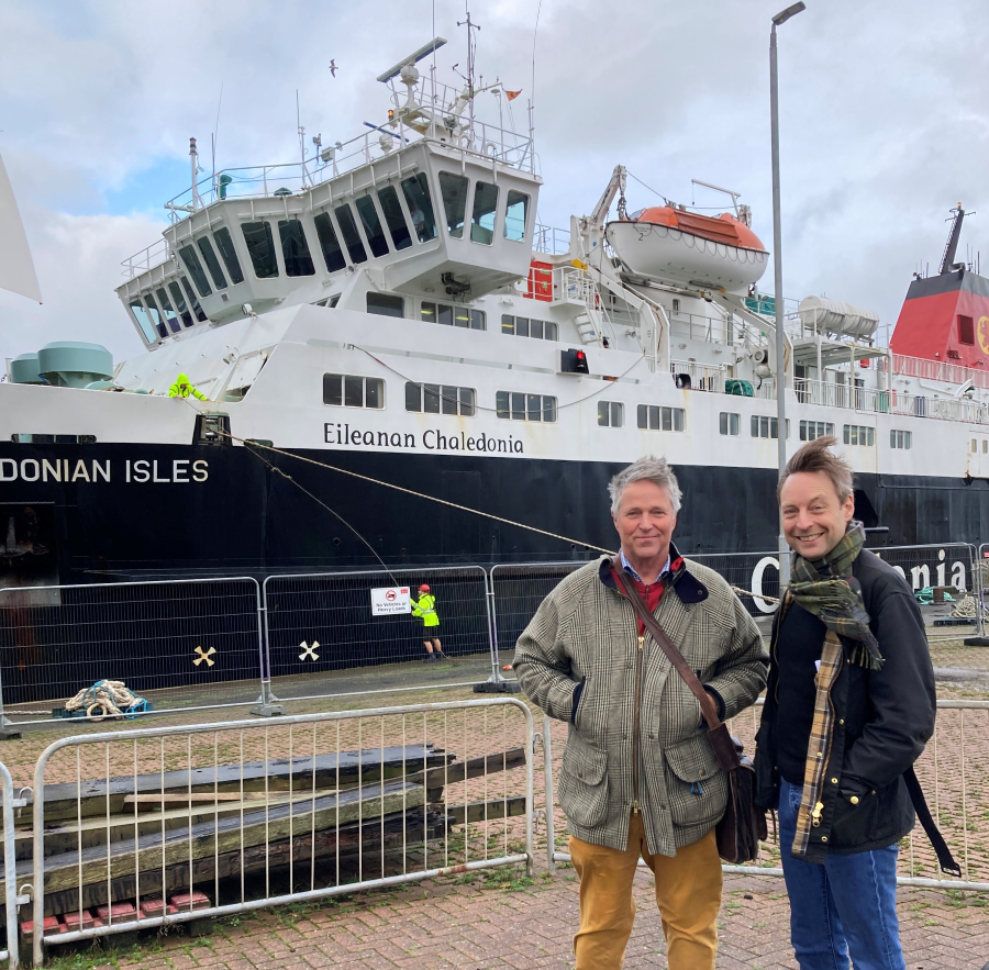Committee Members Edward Mountain and Liam Kerr pose for a photograph by the MV Caledonian Isles ferry.